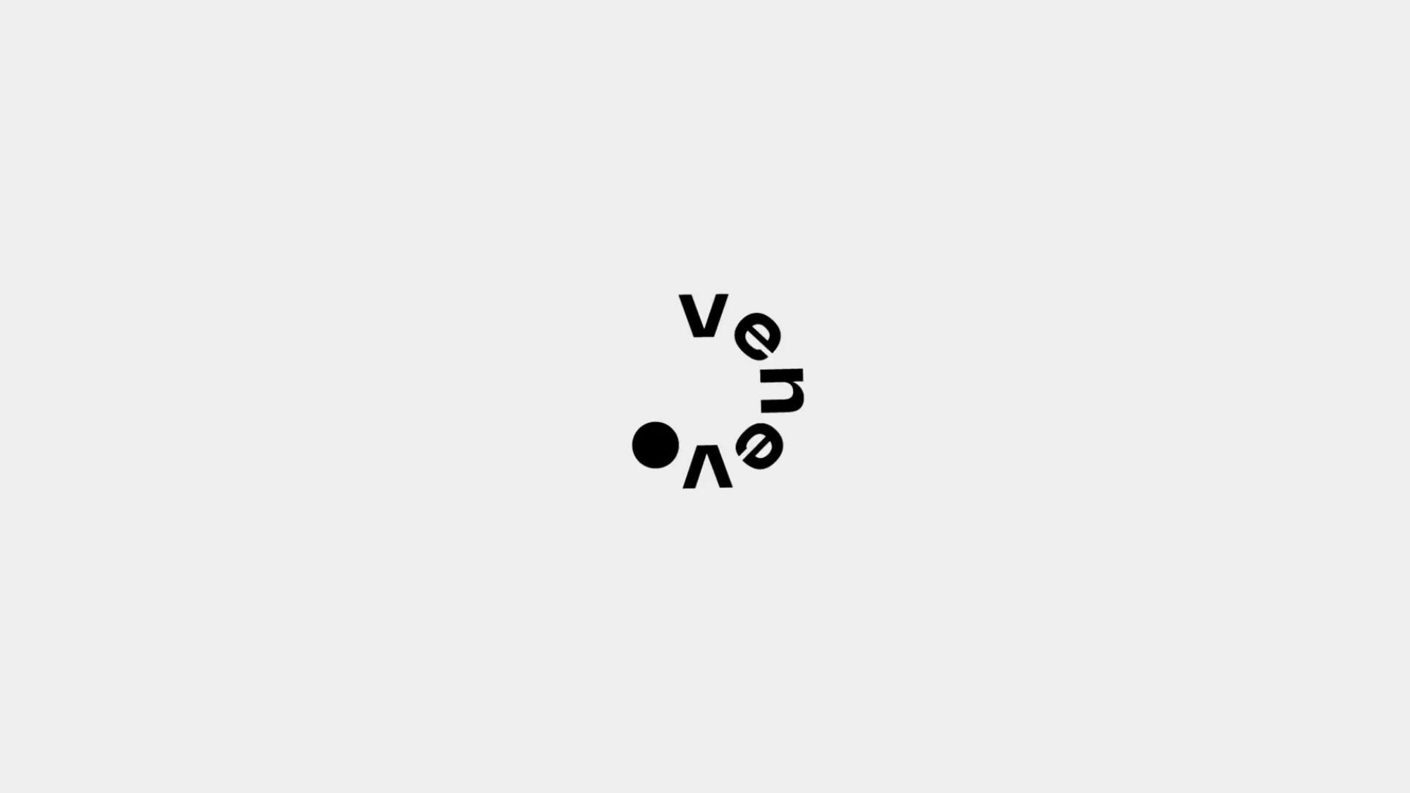 The letters of venevo set in a circle around a black dot