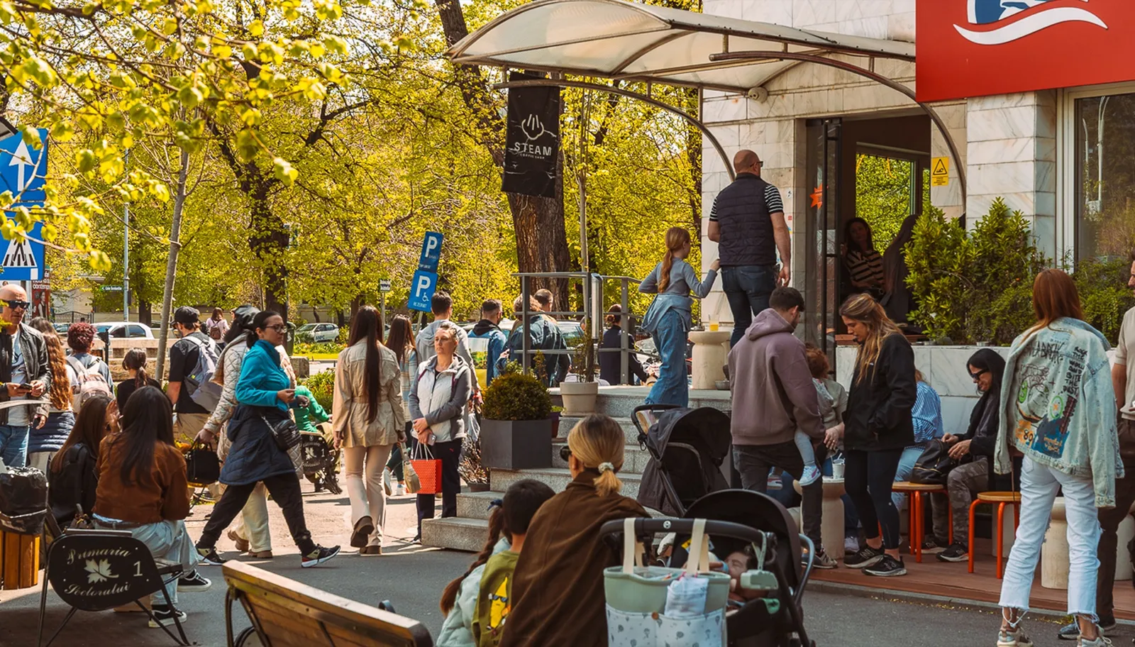 A crowd outside Steam on a sunny day