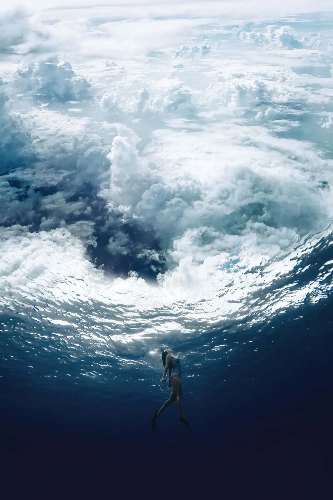 A diver beneath a wave