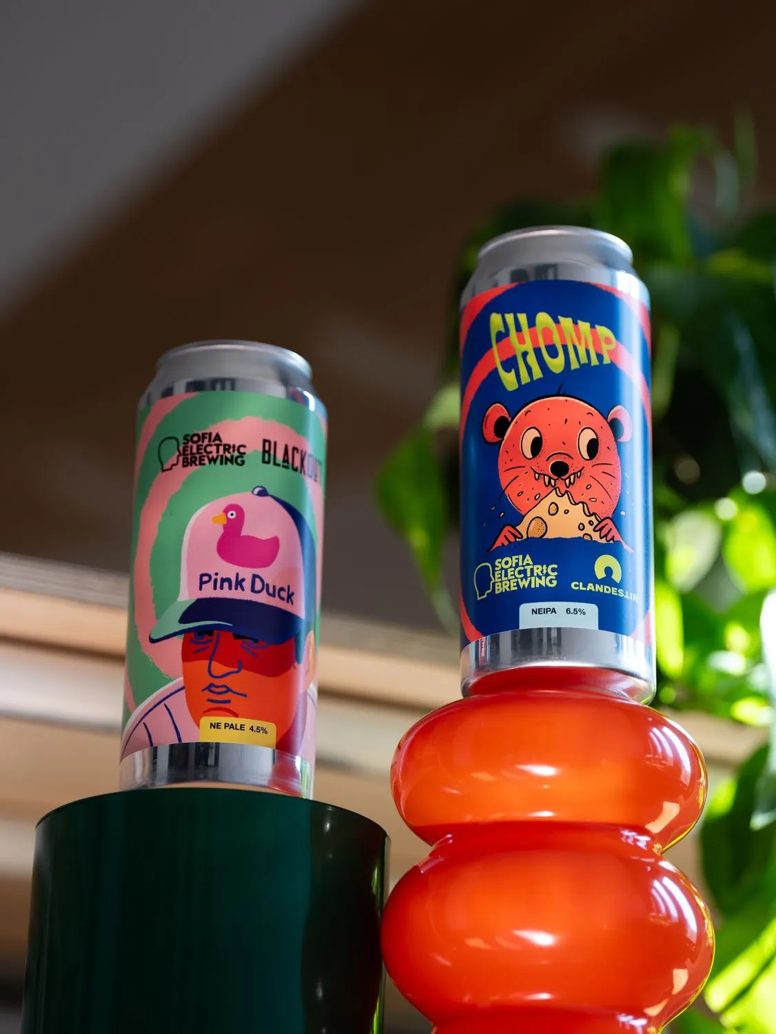 Two cans on coloured plinths