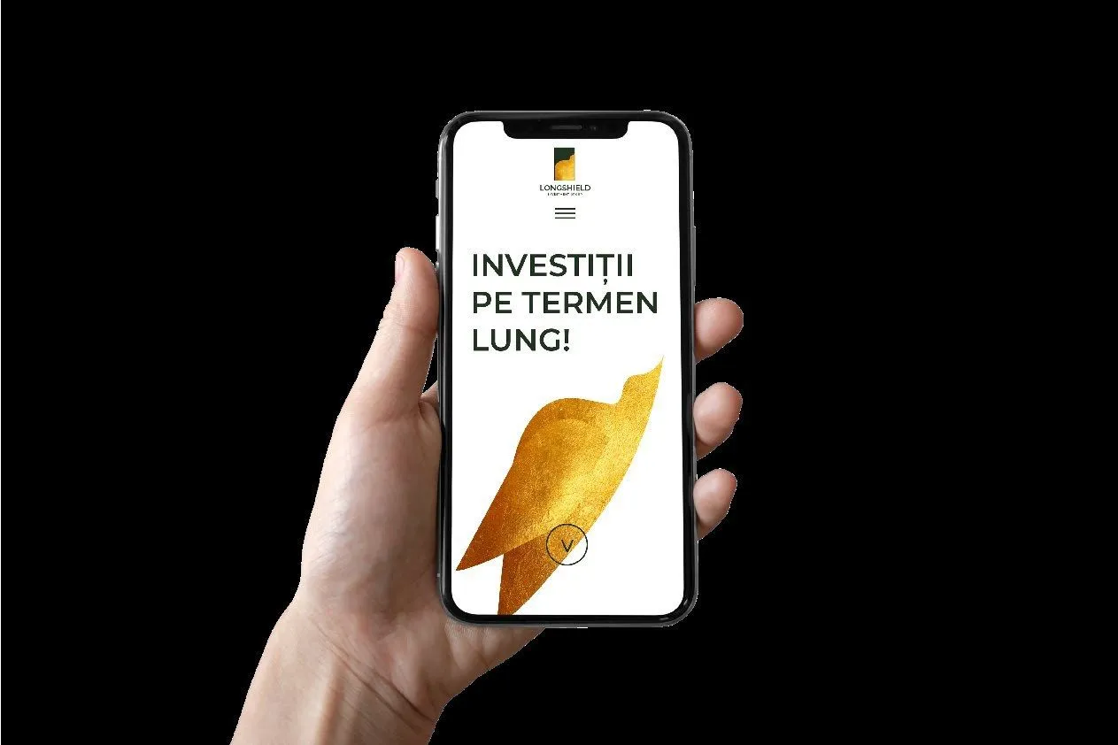 The website on a phone, held in hand