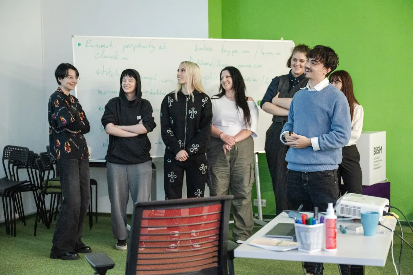 A team of students presenting in front of a whiteboard