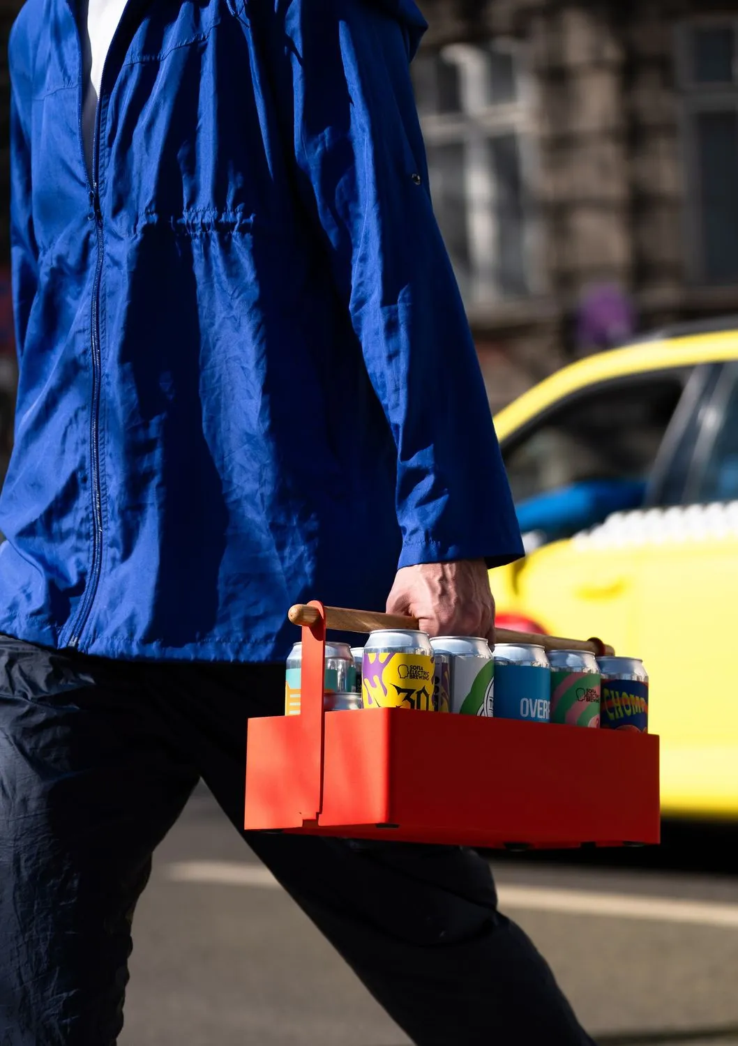 Walking with the red crate across the street