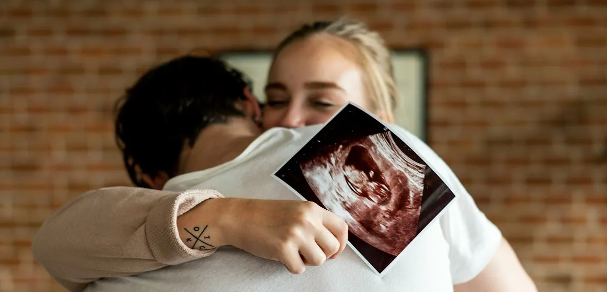 Maternal-fetal medicine: a couple holding an ultrasound print