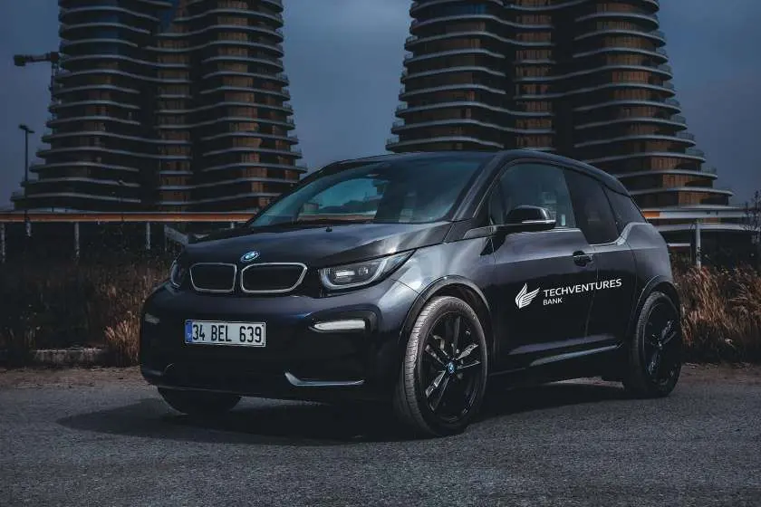A branded electric car among towers