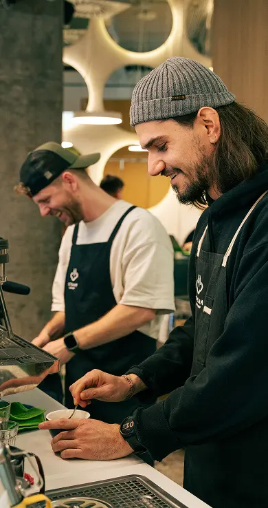 Barista preparing coffee behind the bar