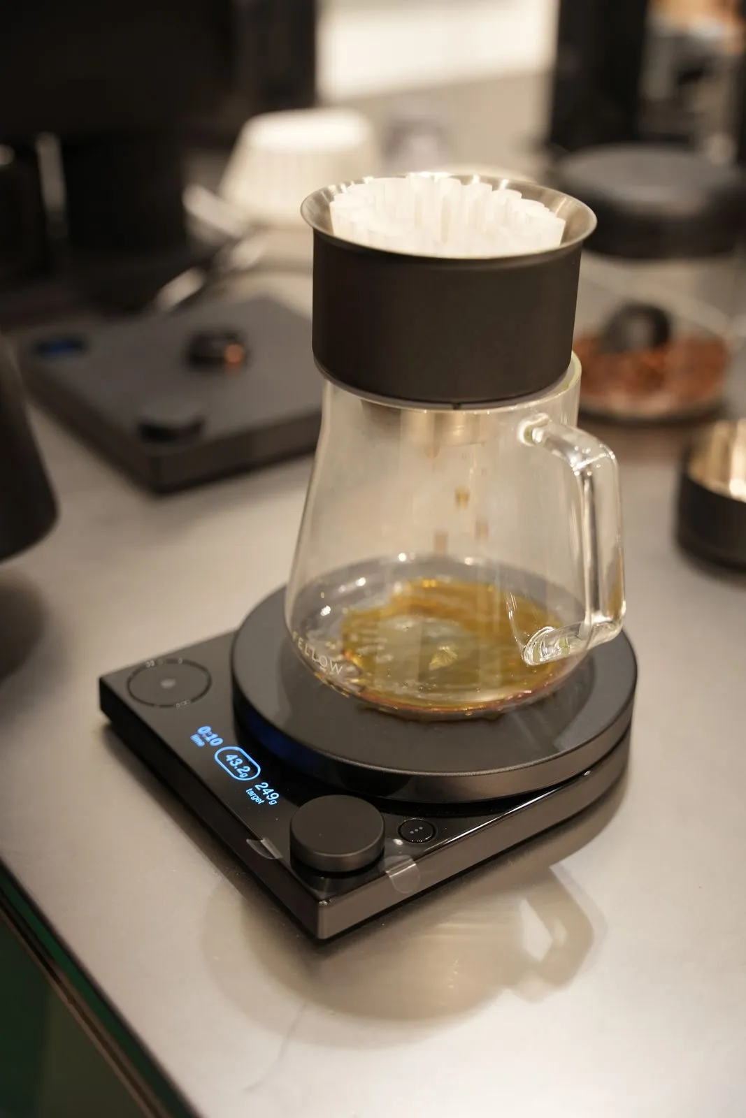 A glass carafe of filter coffee on a Fellow scale