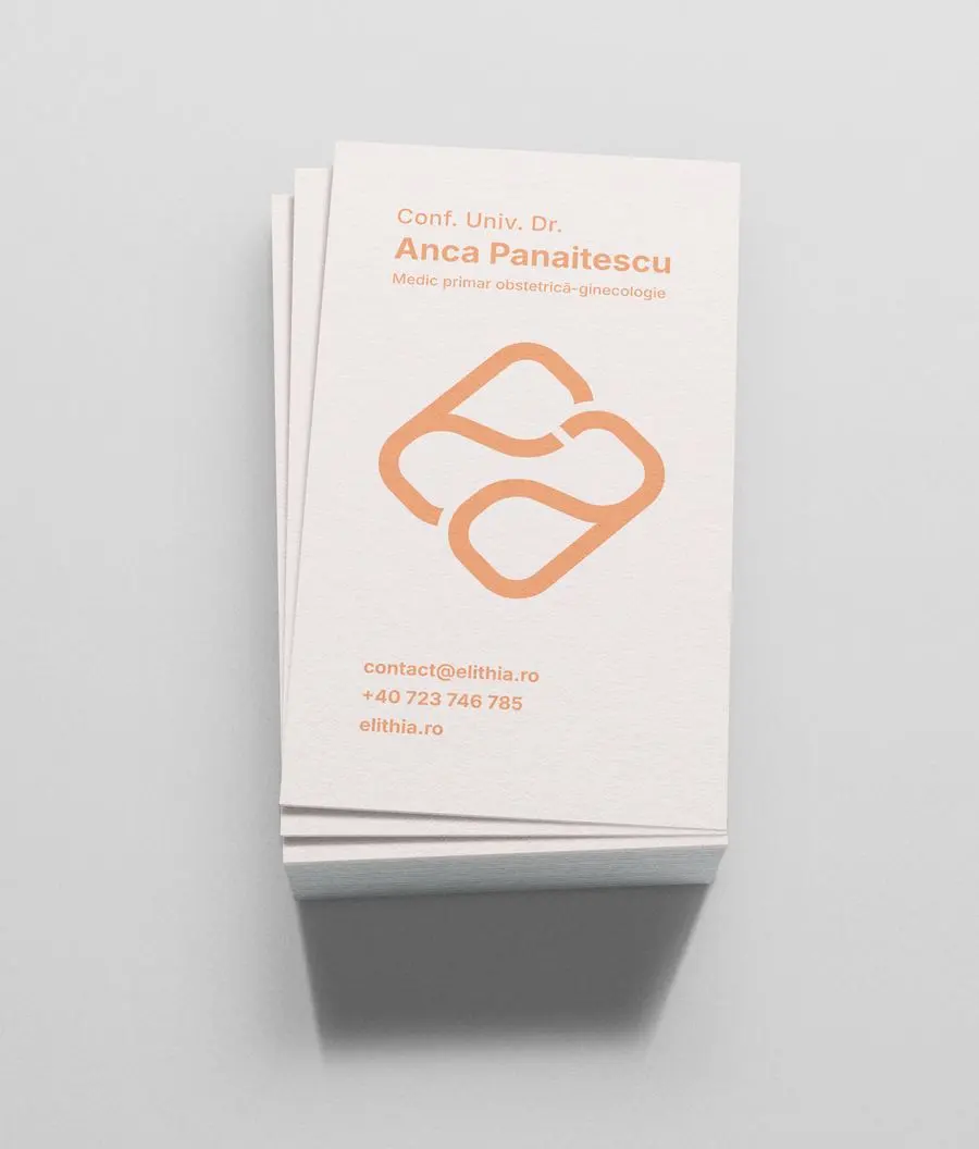 A doctor's business card in peach with the Elithia symbol