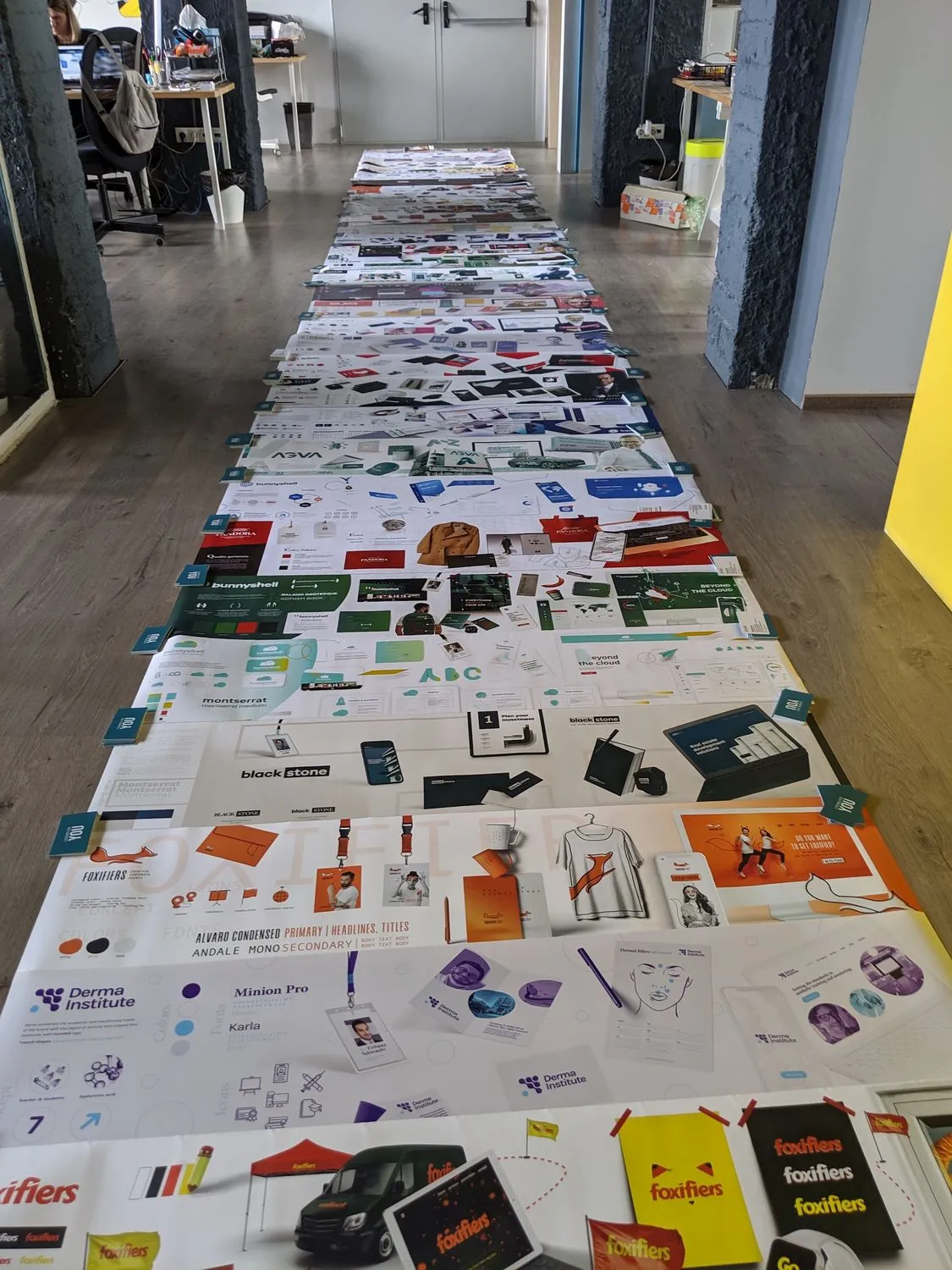 Prints laid out along the long table for a review