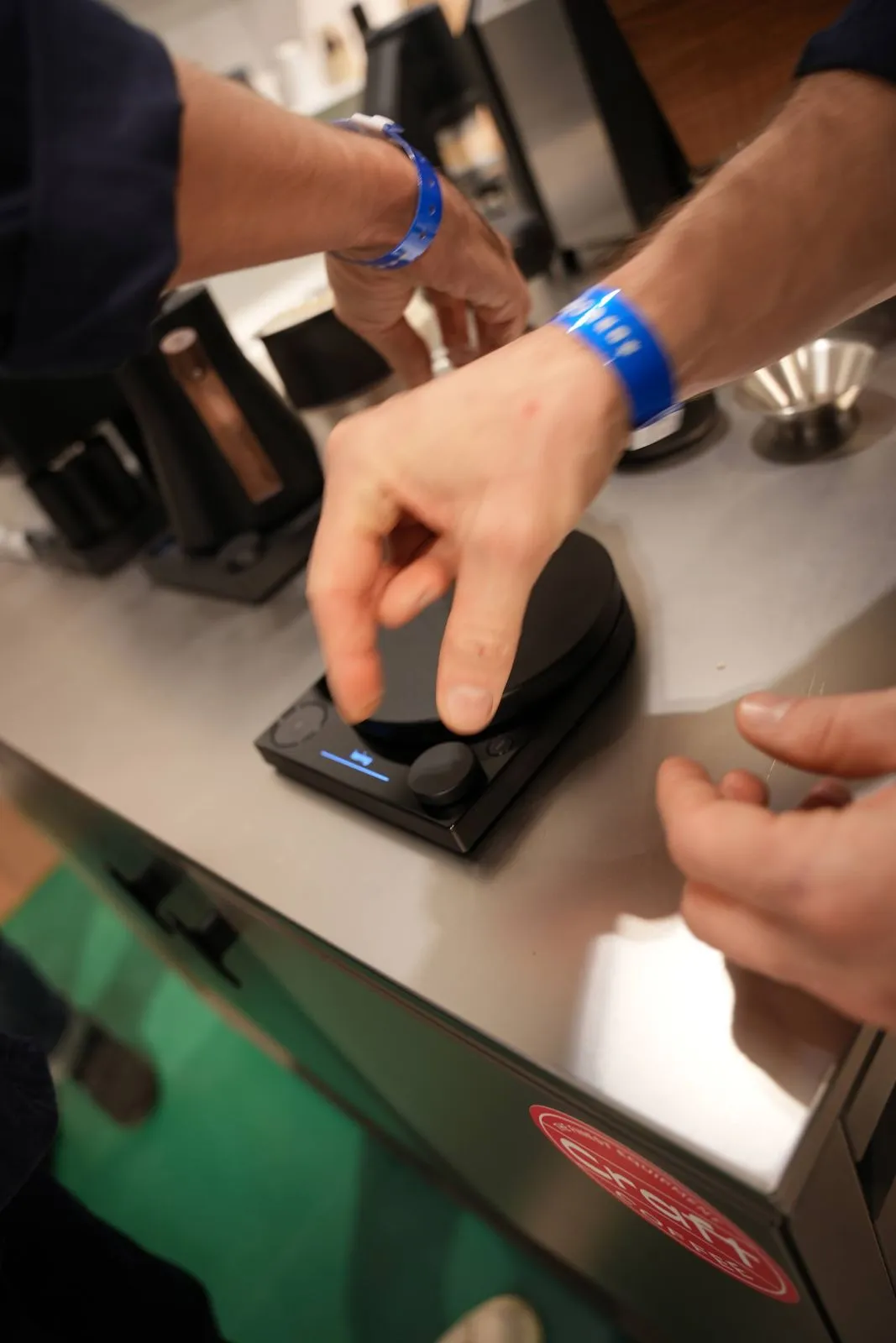 A hand setting a Fellow scale