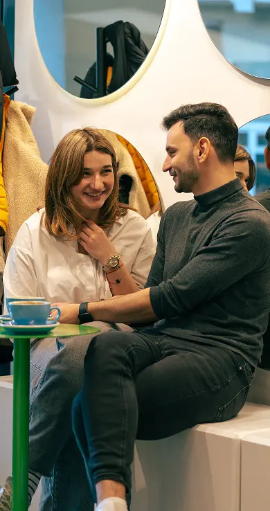 Two guests talking over coffee