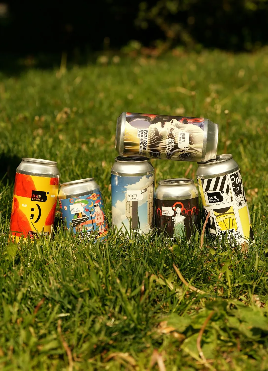 A pyramid of cans on the grass
