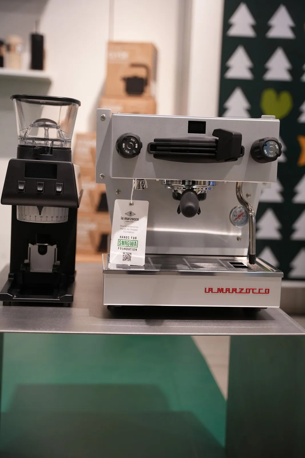 A La Marzocco machine and grinder at the stand