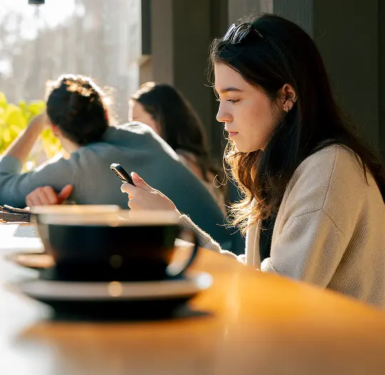 A guest holding a cup at the counter