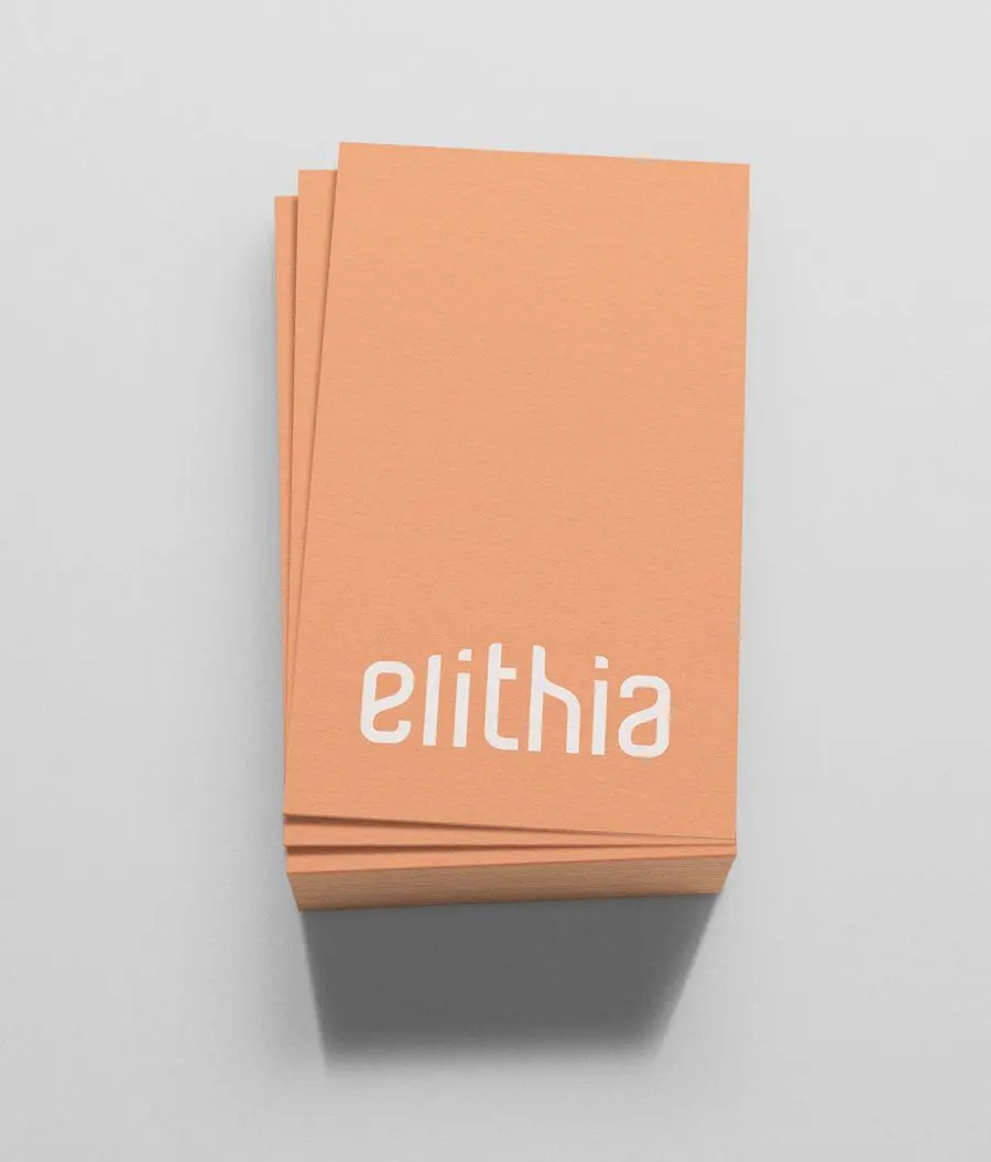 A stack of peach Elithia business cards