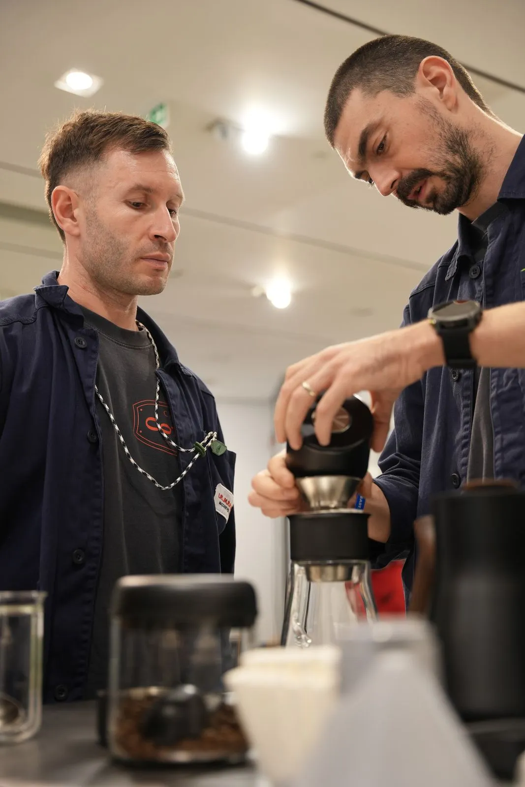 Two team members brewing coffee